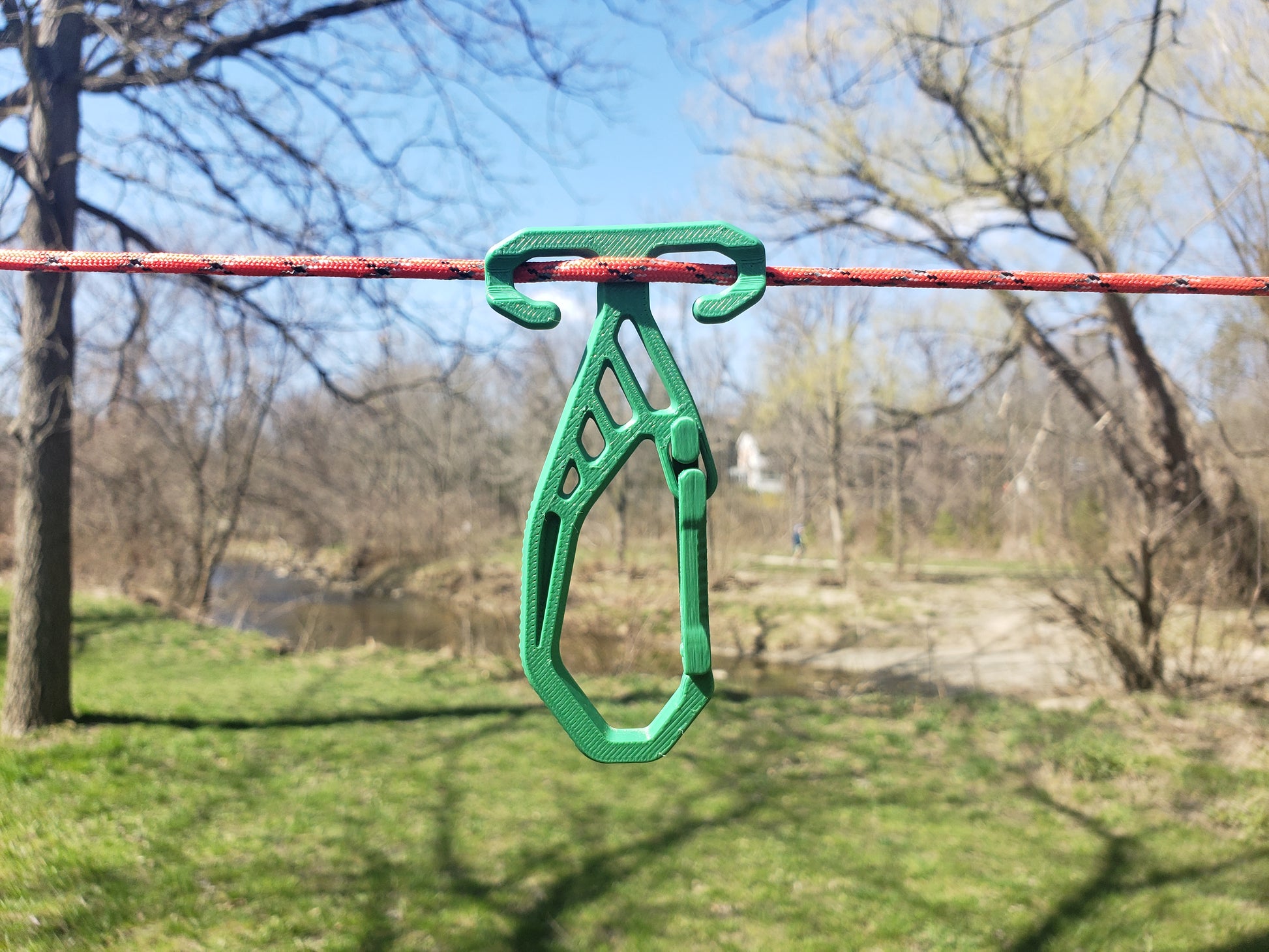 Green RidgeClip attached to a rope with a natural background