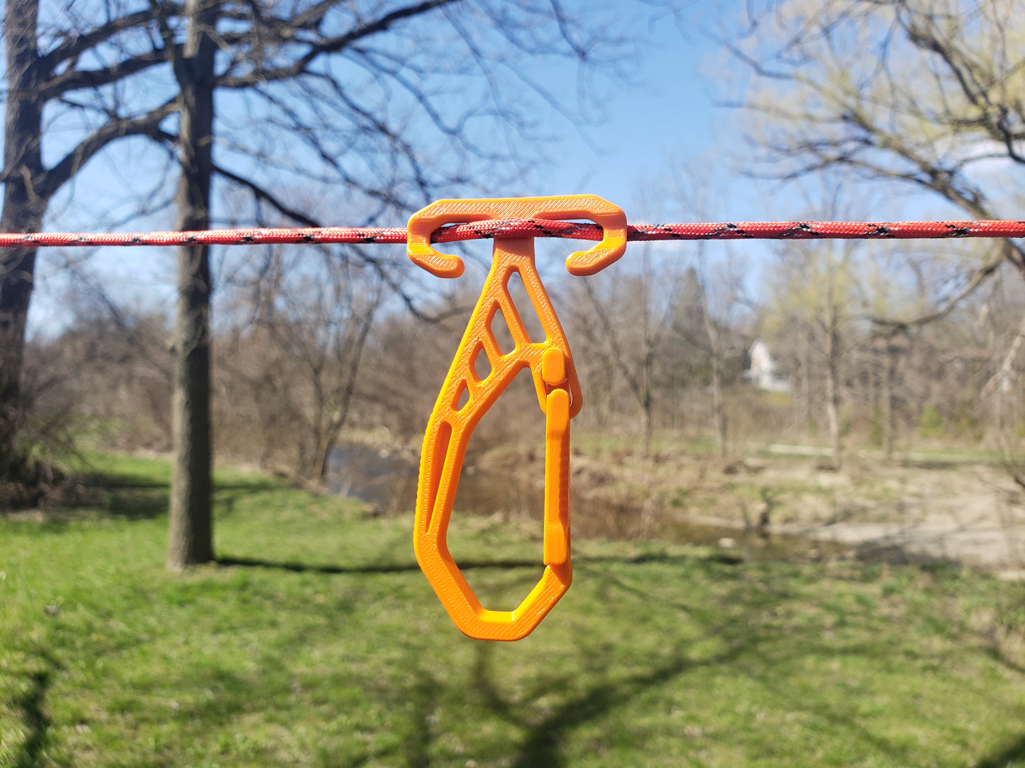 Orange RidgeClip on a rope with a blurred natural background