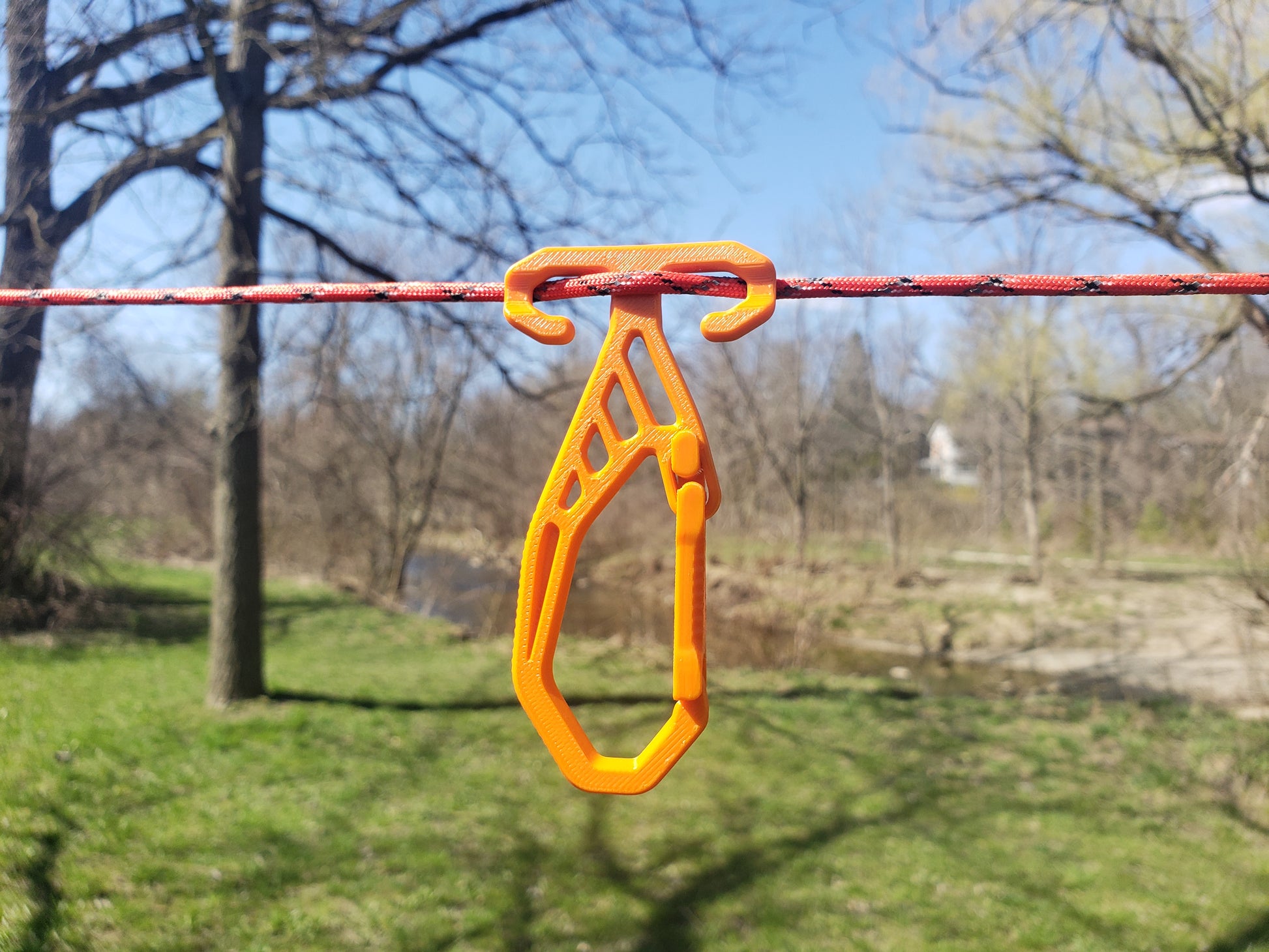 Orange RidgeClip on a rope with a blurred natural background