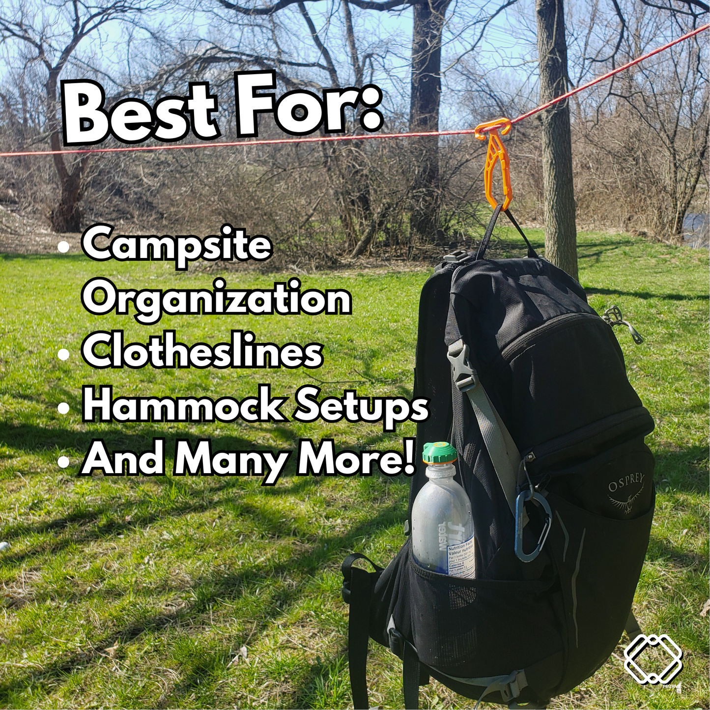 Black backpack with clothesline attachments on a grassy campsite
